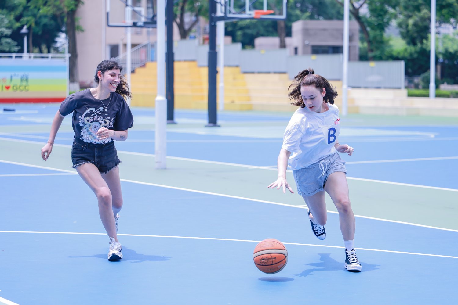 Dribbling down the blue court in the morning heat, the trees offering more shade than mercy.