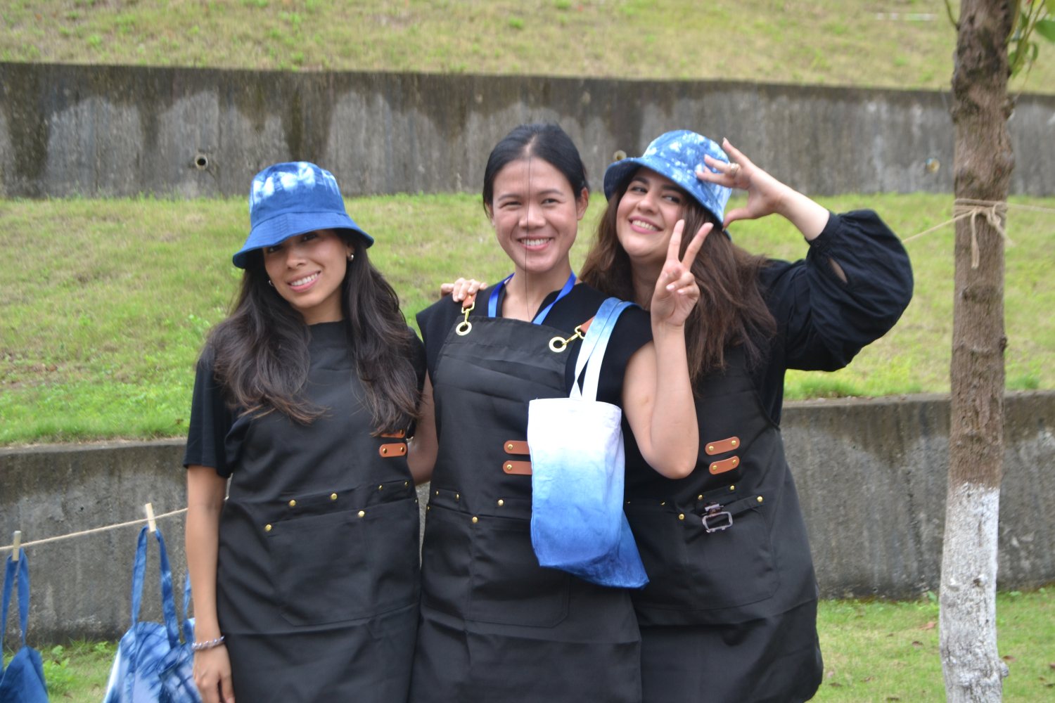 Aprons on, blue tie-dyed hats on, our finished cloths drying on the line behind us