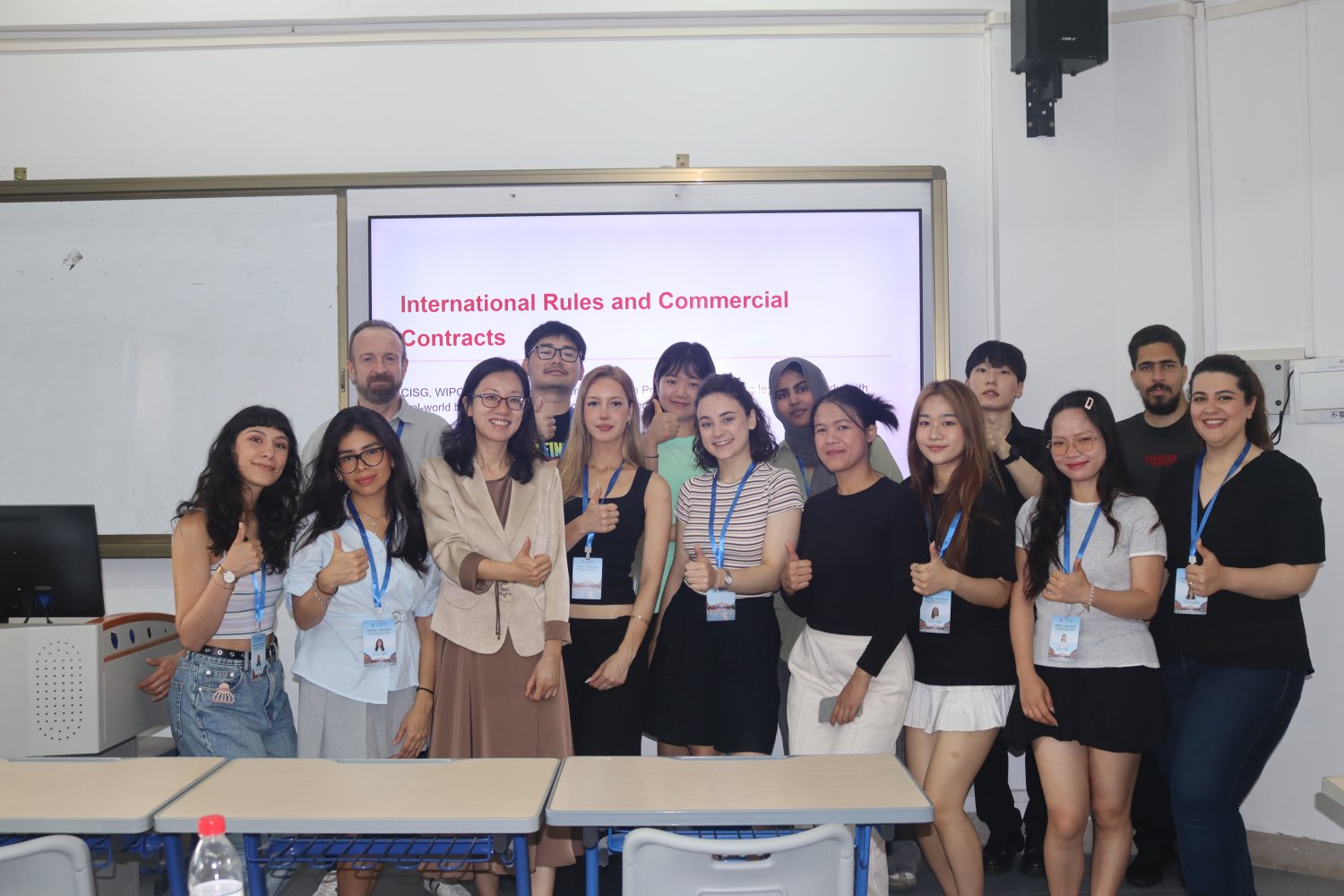The whole class in front of the slide that framed our morning: "International Rules and Commercial Contracts".